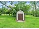 Exterior view of the backyard shed with double doors and green grass; convenient outdoor storage solution at 10972 W Old Nashville Rd, Columbus, IN 47201