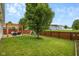 Spacious backyard with a pergola, seating, play set, and wood fence at 11209 Black Gold Dr, Noblesville, IN 46060