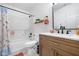 Well-lit bathroom featuring a wooden vanity and a shower with floral curtain at 11209 Black Gold Dr, Noblesville, IN 46060