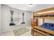 Bedroom featuring wood bunk beds, a bright window, neutral paint, and soft carpeting at 11209 Black Gold Dr, Noblesville, IN 46060