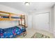 Bright bedroom featuring a wooden bunk bed and a large closet with white doors at 11209 Black Gold Dr, Noblesville, IN 46060