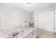 Bright bedroom with a bed, desk, and a closet with white doors at 11209 Black Gold Dr, Noblesville, IN 46060