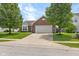 Charming single Gathering home with two car garage, brick facade, and front yard with mature landscaping at 11209 Black Gold Dr, Noblesville, IN 46060