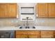 Bright kitchen features stainless steel sink, modern tile backsplash and natural wood cabinetry at 11209 Black Gold Dr, Noblesville, IN 46060