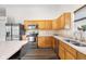 Well-equipped kitchen featuring stainless steel appliances, ample counter space, and oak cabinetry for a modern look at 11209 Black Gold Dr, Noblesville, IN 46060