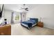 Spacious bedroom features a ceiling fan, neutral carpet and paint, and large sunny window at 11209 Black Gold Dr, Noblesville, IN 46060