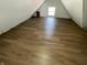 Spacious attic area with sloped ceilings, natural light, and durable flooring at 1164 Groff Ave, Indianapolis, IN 46222