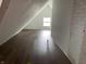 A finished attic space with hardwood floors and a window at 1164 Groff Ave, Indianapolis, IN 46222