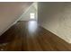 Bright attic space featuring wood-look flooring and natural light from a window at 1164 Groff Ave, Indianapolis, IN 46222