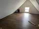 A finished attic space with hardwood floors and a window at 1164 Groff Ave, Indianapolis, IN 46222