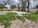 Large gravel backyard featuring a new wooden fence and scattered greenery with mature trees in a residential neighborhood at 1164 Groff Ave, Indianapolis, IN 46222