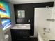 Functional bathroom showcasing a vanity, toilet, and tiled shower over tub at 1164 Groff Ave, Indianapolis, IN 46222