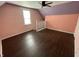 Cozy bedroom featuring vinyl floors, a ceiling fan, and natural light from the window at 1164 Groff Ave, Indianapolis, IN 46222