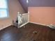 Bedroom showcasing hardwood floors, and a large window offering natural light at 1164 Groff Ave, Indianapolis, IN 46222