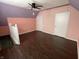 Bright bedroom boasting dark vinyl floors, a ceiling fan, and ample closet space at 1164 Groff Ave, Indianapolis, IN 46222