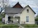 Charming two-story home featuring a welcoming porch and a well-maintained, fenced yard under an overcast sky at 1164 Groff Ave, Indianapolis, IN 46222