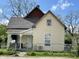 Charming two-story home featuring a welcoming porch and a well-maintained, fenced yard under a bright blue sky at 1164 Groff Ave, Indianapolis, IN 46222