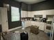 A well-lit kitchen featuring white cabinetry and essential appliances at 1164 Groff Ave, Indianapolis, IN 46222