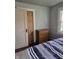 Bedroom with wood door, closet, and dresser at 1168 N Gladstone Ave, Indianapolis, IN 46201