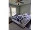 Bedroom with a bed, ceiling fan, and windows at 1168 N Gladstone Ave, Indianapolis, IN 46201