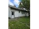 Shows the side of a small white house with a side door and windows at 1168 N Gladstone Ave, Indianapolis, IN 46201