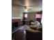Cozy living room with brick fireplace, hardwood floors, and comfortable leather chairs at 1168 N Gladstone Ave, Indianapolis, IN 46201