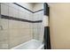 Full bathroom showcasing a tub and shower with tiled walls and shower curtain at 1170 N Concord St, Indianapolis, IN 46222