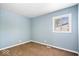 A simple yet cozy bedroom offering carpet, a window and neutral-toned walls at 1170 N Concord St, Indianapolis, IN 46222