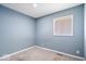 Comfortable bedroom with natural light from the window and neutral carpet, perfect for relaxation at 1170 N Concord St, Indianapolis, IN 46222