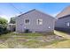 Home's exterior with gray siding and white framed windows under a blue sky at 1170 N Concord St, Indianapolis, IN 46222