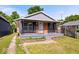 Charming bungalow with brick facade, gray siding, and welcoming front porch at 1170 N Concord St, Indianapolis, IN 46222