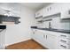 Well-lit kitchen featuring white cabinetry, granite countertops, and wood-look flooring at 1170 N Concord St, Indianapolis, IN 46222