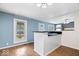 This kitchen features hardwood floors, a breakfast bar and a double window letting in plenty of natural light at 1170 N Concord St, Indianapolis, IN 46222