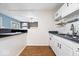 Functional kitchen with white cabinets, black granite countertops, and wood-look flooring at 1170 N Concord St, Indianapolis, IN 46222