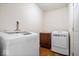 Functional laundry room features modern washer and dryer, plus storage cabinet for convenience at 1170 N Concord St, Indianapolis, IN 46222