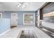 Inviting living room featuring custom shelving, a ceiling fan, and tile flooring at 1170 N Concord St, Indianapolis, IN 46222