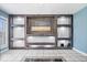 Spacious living room featuring custom shelving, a ceiling fan, and tile flooring at 1170 N Concord St, Indianapolis, IN 46222