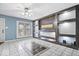 Comfortable living room with custom shelving, fan, and tile flooring at 1170 N Concord St, Indianapolis, IN 46222
