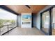 Covered outdoor deck with a wood-paneled ceiling and a brick fireplace at 120 First Ne Ave, Carmel, IN 46032