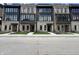 Row of new townhomes with mixed brick and stone exteriors, black window frames, and manicured landscaping at 120 First Ne Ave, Carmel, IN 46032