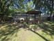 The backyard features a wooden gazebo and deck that adjoins the home and offers outdoor living space at 1263 Barefoot Trl, Greenwood, IN 46142