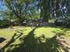 The home's backyard has a gazebo and fire pit, surrounded by trees and well-maintained grass at 1263 Barefoot Trl, Greenwood, IN 46142