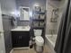 Nicely appointed bathroom featuring tile floors, a sink, a shower, and storage shelves at 1263 Barefoot Trl, Greenwood, IN 46142