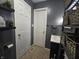 Well-lit bathroom featuring a sink and cabinet, white doors, and woven basket storage at 1263 Barefoot Trl, Greenwood, IN 46142