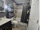 Bathroom with tile floors, dark gray walls, shower with gray curtain, shelving, and a sink at 1263 Barefoot Trl, Greenwood, IN 46142