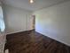 This bedroom has a window, wood floors, and a view into an ensuite bath at 1263 Barefoot Trl, Greenwood, IN 46142