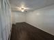 Bedroom featuring dark wood floors, fan, closet with folding doors, and walls at 1263 Barefoot Trl, Greenwood, IN 46142