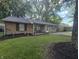 Well-kept single-story home featuring a brick facade and quaint front porch at 1263 Barefoot Trl, Greenwood, IN 46142