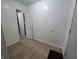 Hallway featuring tile floors, white walls, and access to additional rooms at 1263 Barefoot Trl, Greenwood, IN 46142