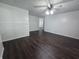 Bright living room featuring updated dark wood floors, white walls, and fan at 1263 Barefoot Trl, Greenwood, IN 46142